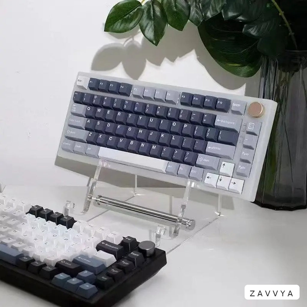 Clear acrylic keyboard stand in a desk setup