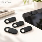 Black webcam covers beside a generic laptop with one cover installed